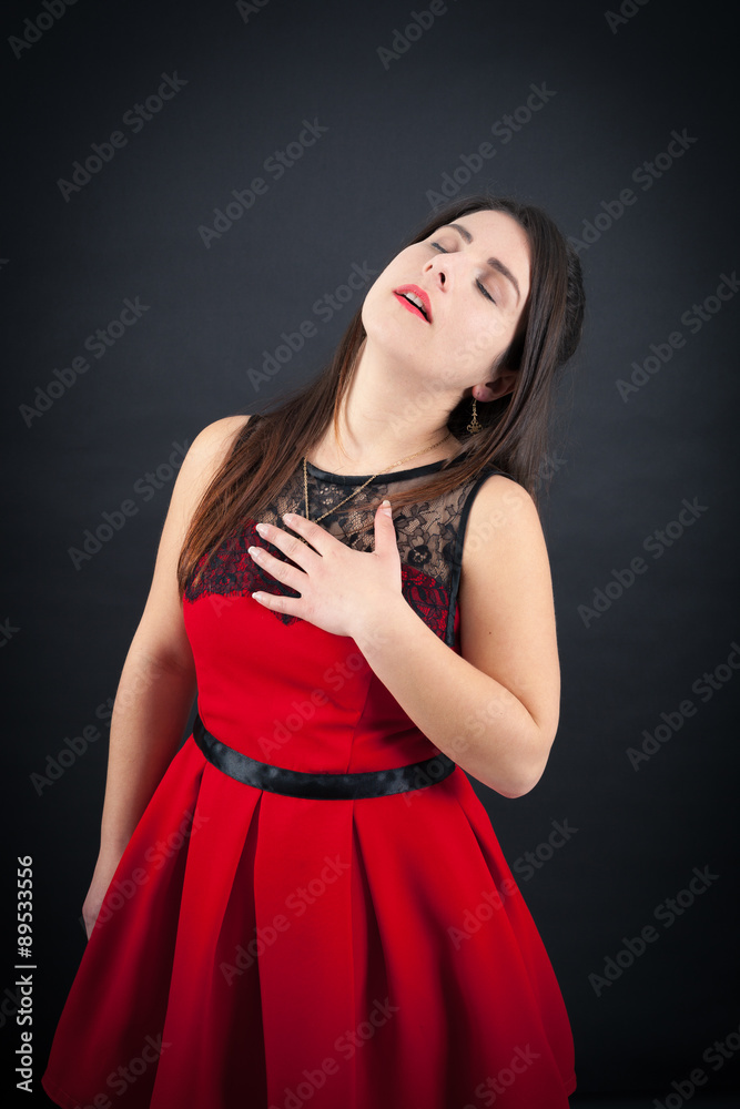 Beautiful woman doing different expressions in different sets of clothes: heart attack Beautiful woman doing different expressions in different sets of clothes: heart attack