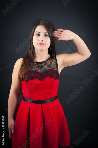 Beautiful woman doing different expressions in different sets of clothes: at attention