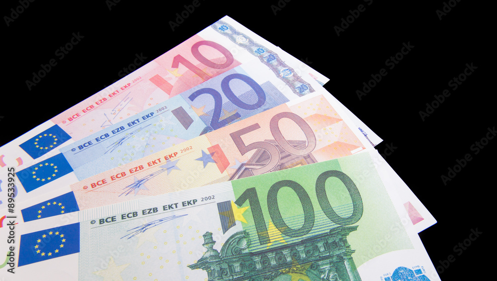Obraz premium Various euro notes on black background