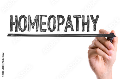 Hand with marker writing the word Homeopathy
