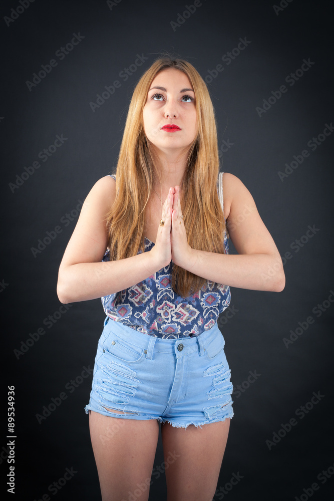 Beautiful girl doing different expressions in different sets of clothes: prayer Beautiful girl doing different expressions in different sets of clothes: prayer