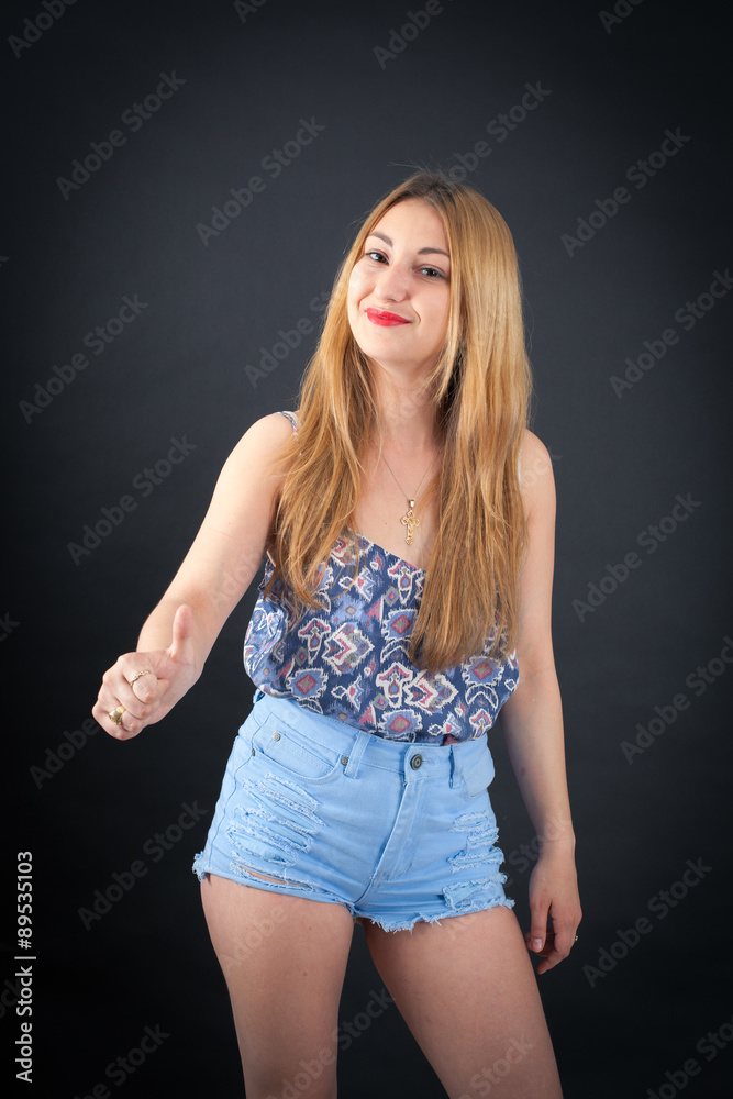 Beautiful girl doing different expressions in different sets of clothes: thumbs up