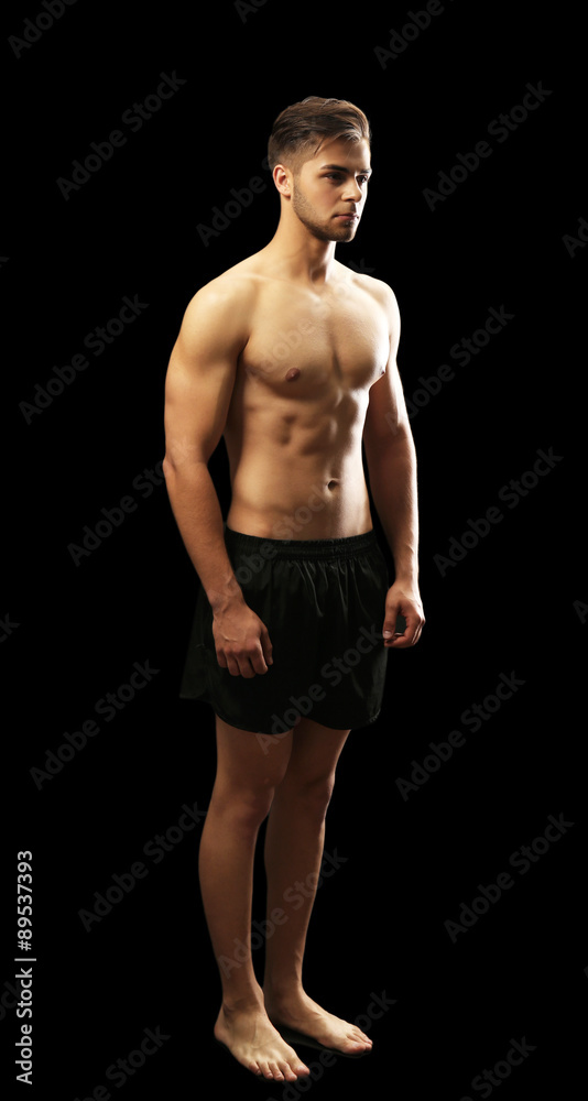Fototapeta premium Muscle young man on dark background
