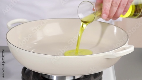 Pouring oil into a deep frying pan