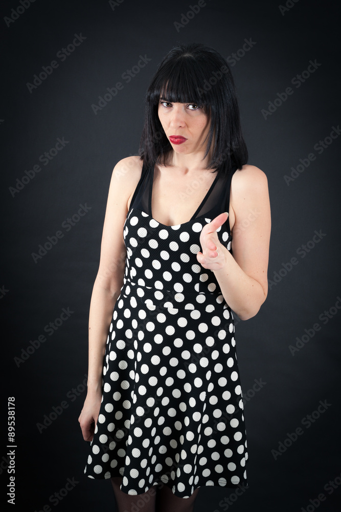 Beautiful woman doing different expressions in different sets of clothes: gun sign Beautiful woman doing different expressions in different sets of clothes: gun sign