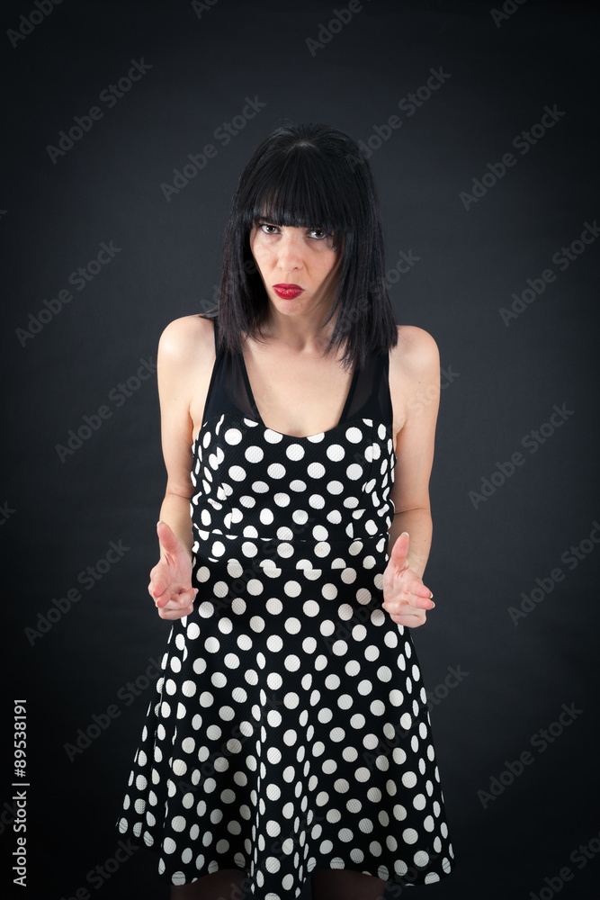 Beautiful woman doing different expressions in different sets of clothes: gun sign Beautiful woman doing different expressions in different sets of clothes: gun sign