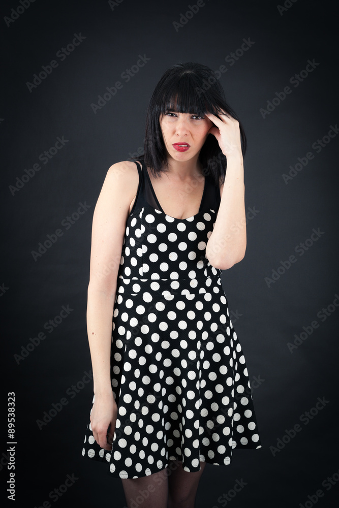 Beautiful woman doing different expressions in different sets of clothes: headache Beautiful woman doing different expressions in different sets of clothes: headache
