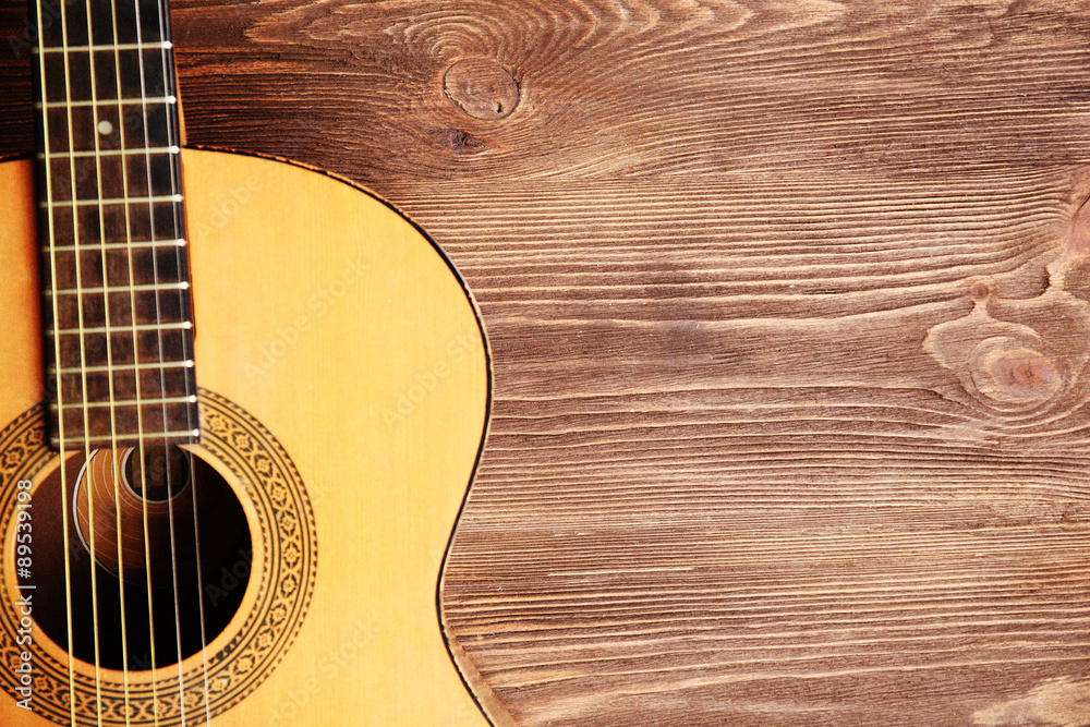 Fototapeta premium Acoustic guitar on wooden background