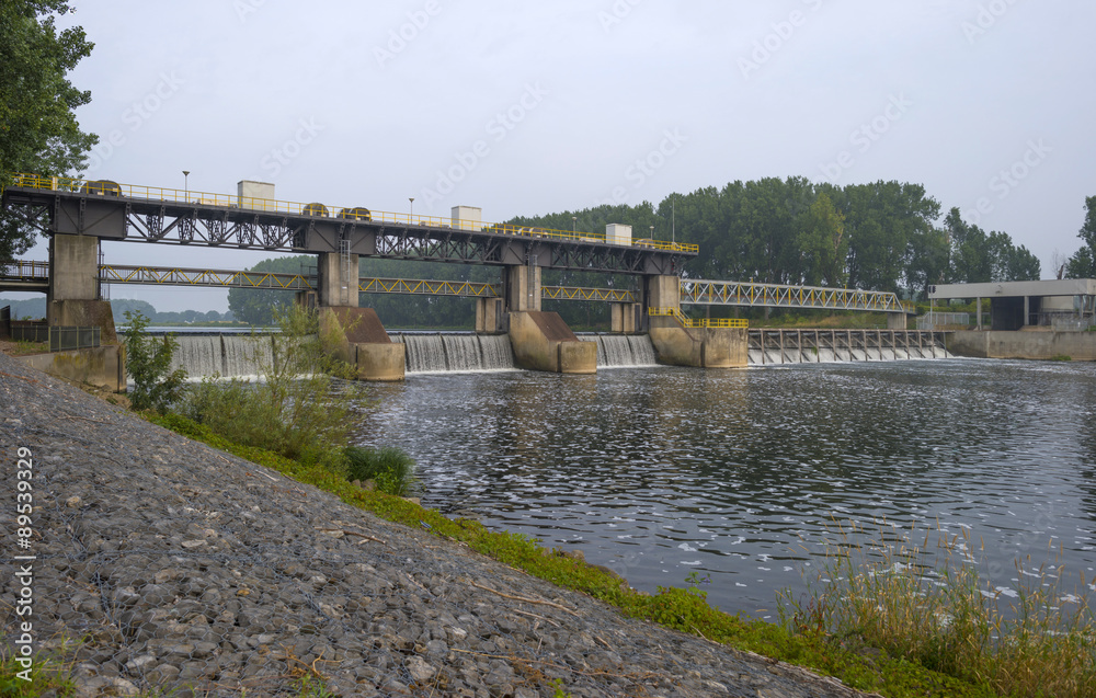 Weir across a river to regulate its flow