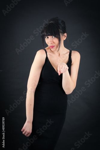 Beautiful woman doing different expressions in different sets of clothes: pointing