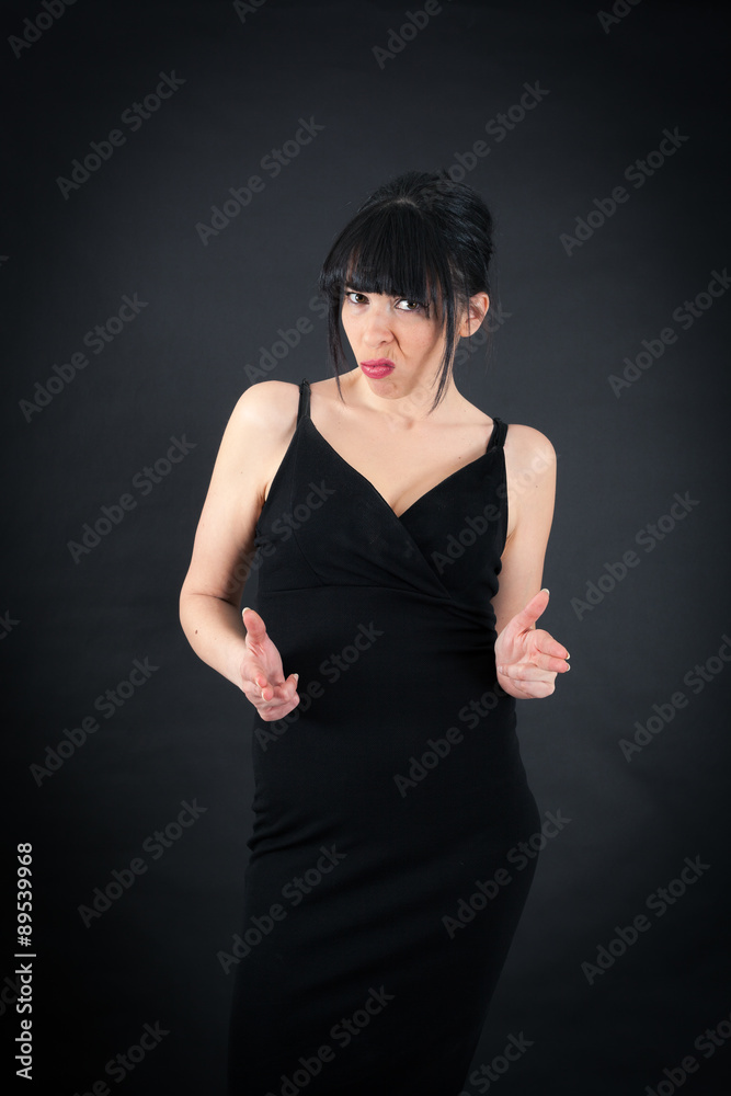 Fototapeta premium Beautiful woman doing different expressions in different sets of clothes: gun sign