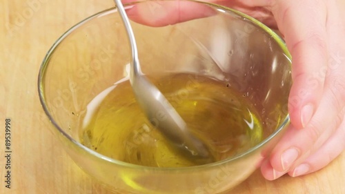 A salad dressing being stirred photo