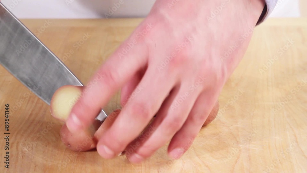 Potatoes cooked in their skins being chopped Potatoes cooked in their skins being chopped