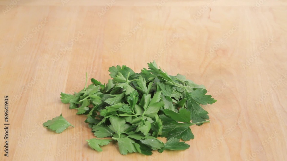 Parsley leaves being removed and chopped Parsley leaves being removed and chopped