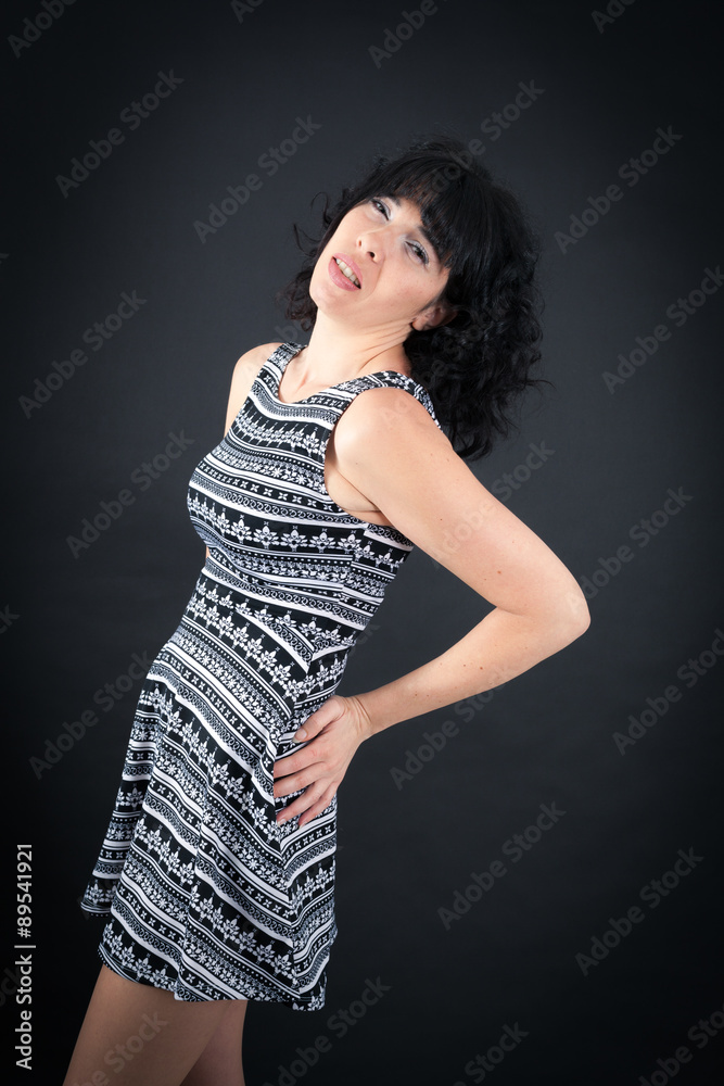 Fototapeta premium Beautiful woman doing different expressions in different sets of clothes: backache