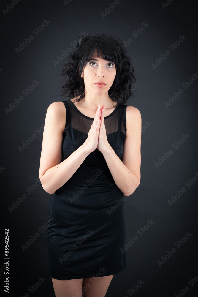 Beautiful woman doing different expressions in different sets of clothes: prayer Beautiful woman doing different expressions in different sets of clothes: prayer