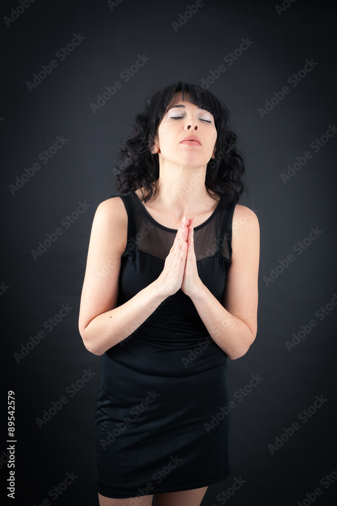 Beautiful woman doing different expressions in different sets of clothes: prayer Beautiful woman doing different expressions in different sets of clothes: prayer