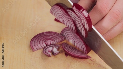 Red onions being cut into half rings