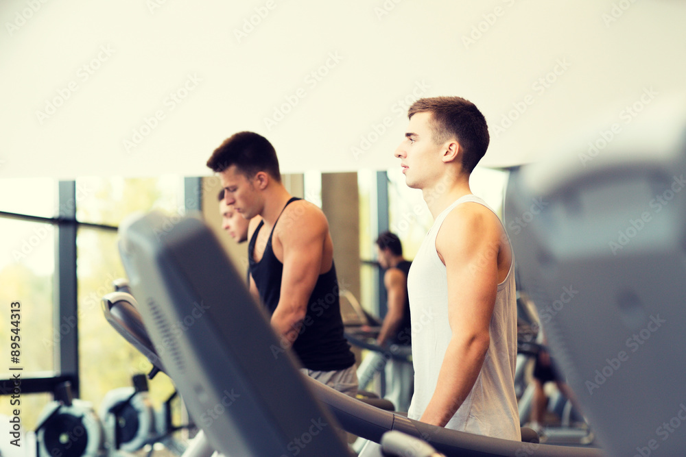 group of men exercising on treadmill in gym group of men exercising on treadmill in gym