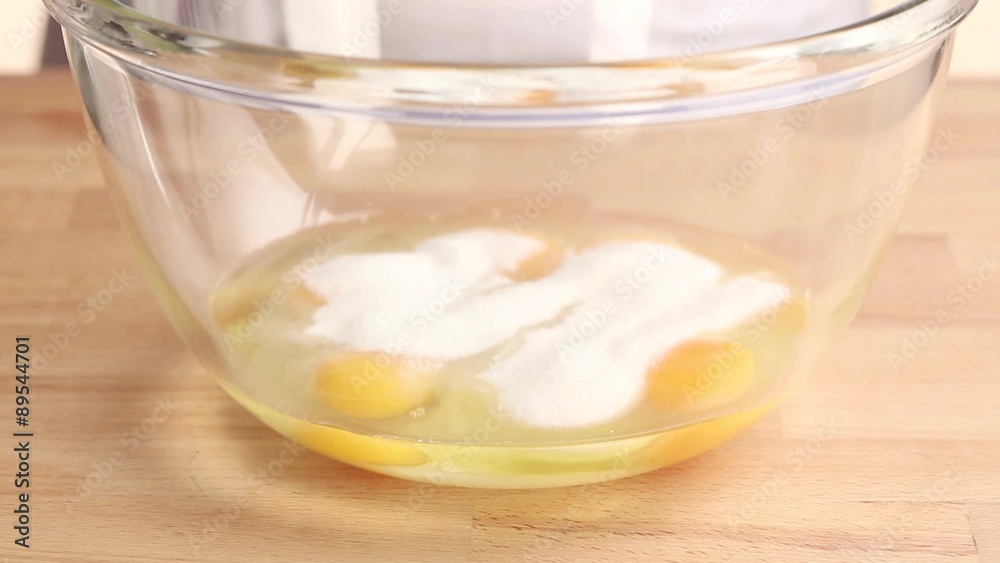 Eggs and sugar being mixed with an electric whisk Eggs and sugar being mixed with an electric whisk