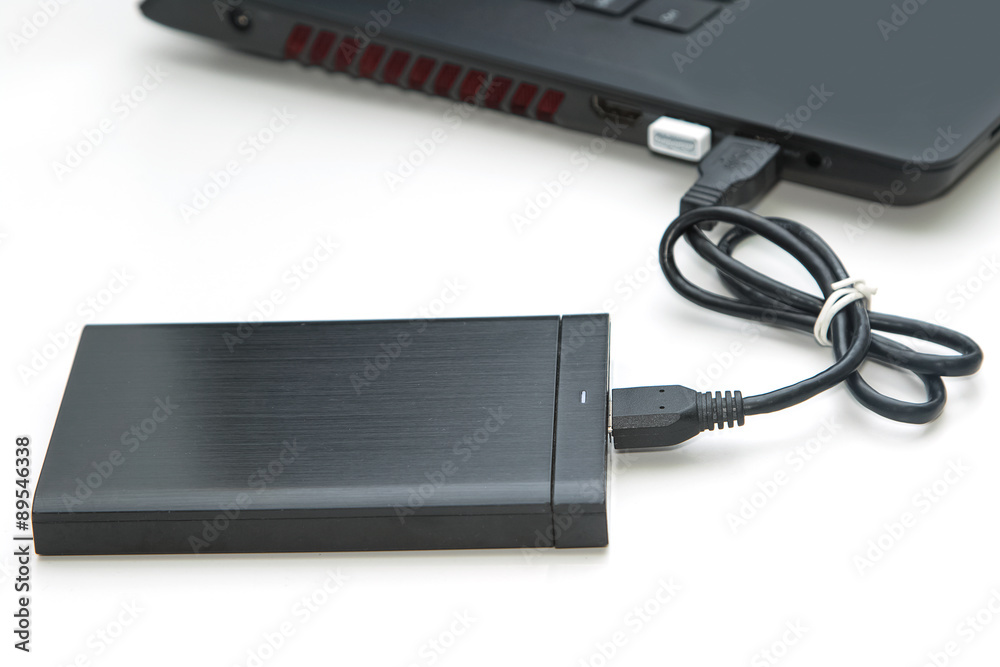 external hard disk connect to computer notebook on white. external hard disk connect to computer notebook on white.