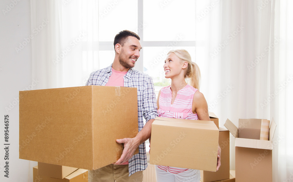 couple with big cardboard boxes moving to new home couple with big cardboard boxes moving to new home