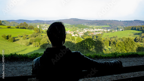recreation in the nature, odenwald, young man sitting on a bench photo