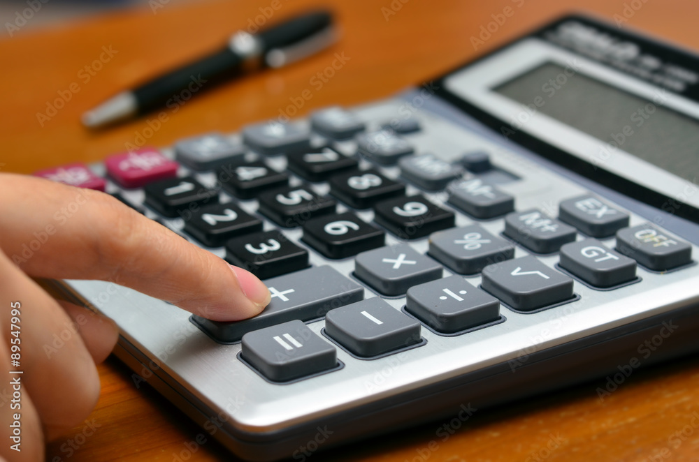 Hand on a calculator (Calculating, business, office objects) Hand on a calculator (Calculating, business, office objects)