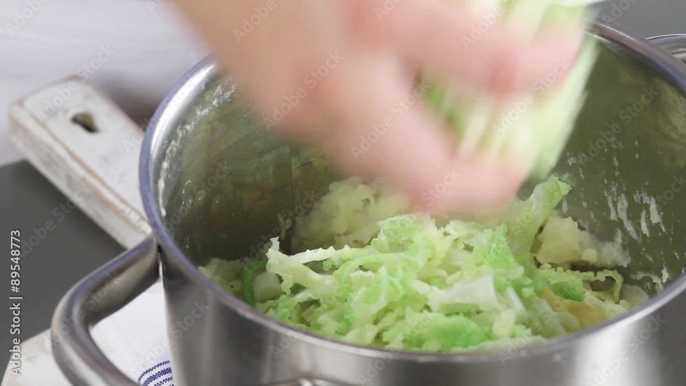 Blanched savoy cabbage being added to mashed potatoes