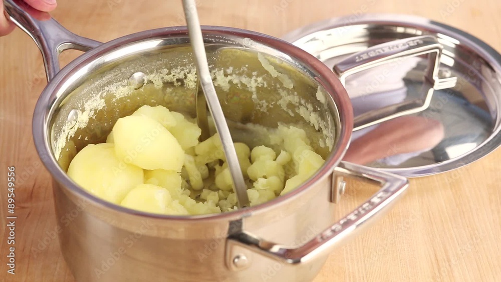 Potatoes being mashed Potatoes being mashed