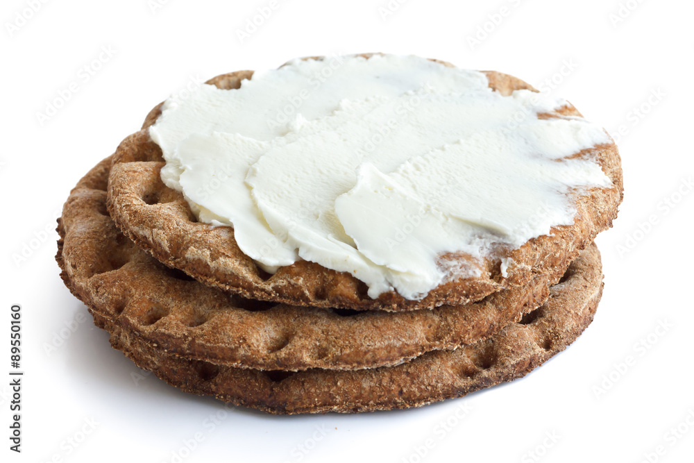 Stack of round rye crispbreads isolated on white. Top one spread Stack of round rye crispbreads isolated on white. Top one spread
