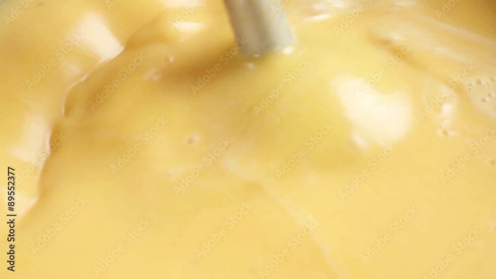 Pureeing pumpkin soup using a hand blender Pureeing pumpkin soup using a hand blender