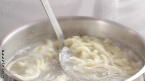 Removing spätzle from water with a slotted spoon