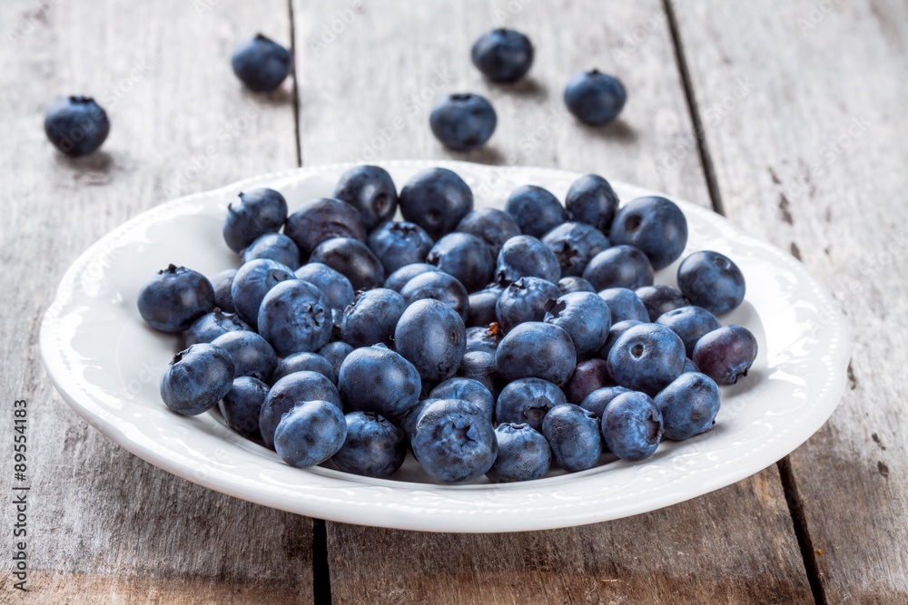 juicy fresh organic blueberries in a plate on a wooden table juicy fresh organic blueberries in a plate on a wooden table