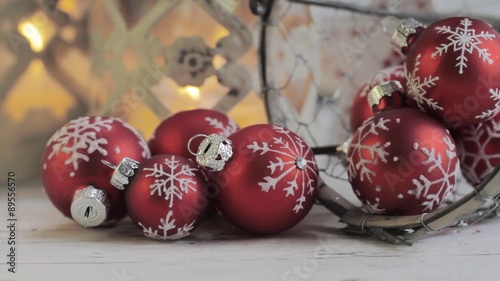 Christmas baubles and burning candles in the backgrounds photo