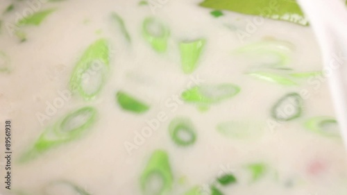 Coconut milk soup being stirred photo