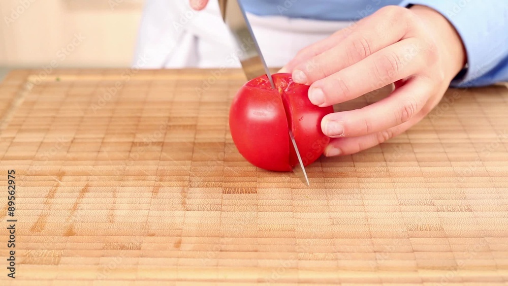 A tomato being chopped A tomato being chopped