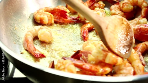 Prawns being fried in a pan photo