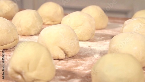 Raw dumplings on a floured wooden board