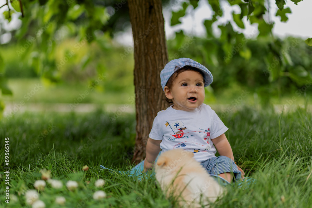 Little baby playing with small dog in the park Little baby playing with small dog in the park