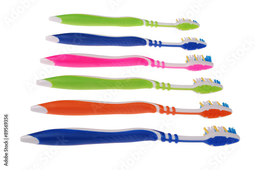 Photos Colored toothbrushes. White background. (6 Clipping paths)