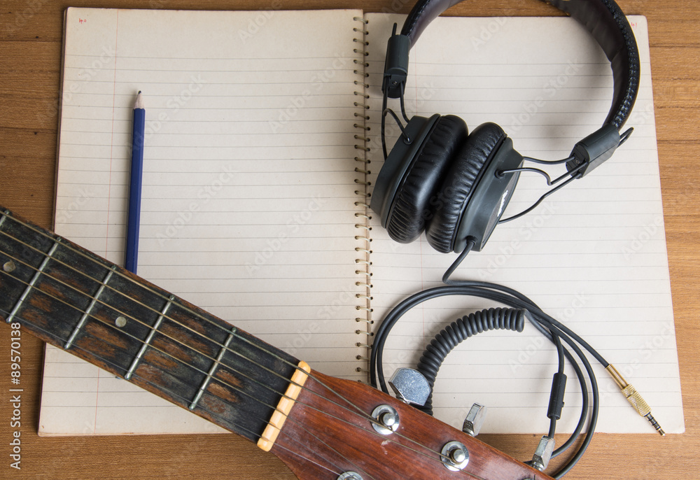 Fototapeta premium headphone guitar notebook and pencil