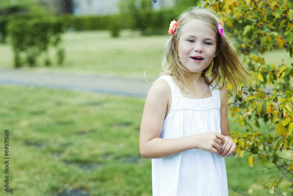 Portrait of smiling girl wearing white summer dress and flowers Portrait of smiling girl wearing white summer dress and flowers