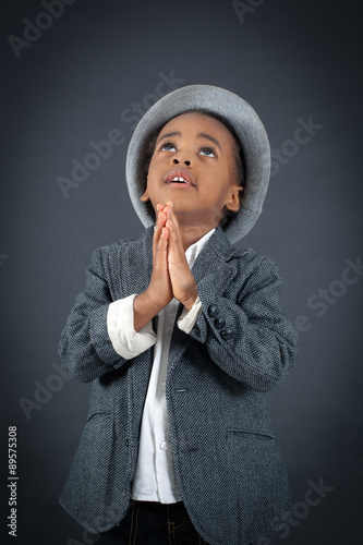 Handsome boy doing different expressions in different sets of clothes: prayer