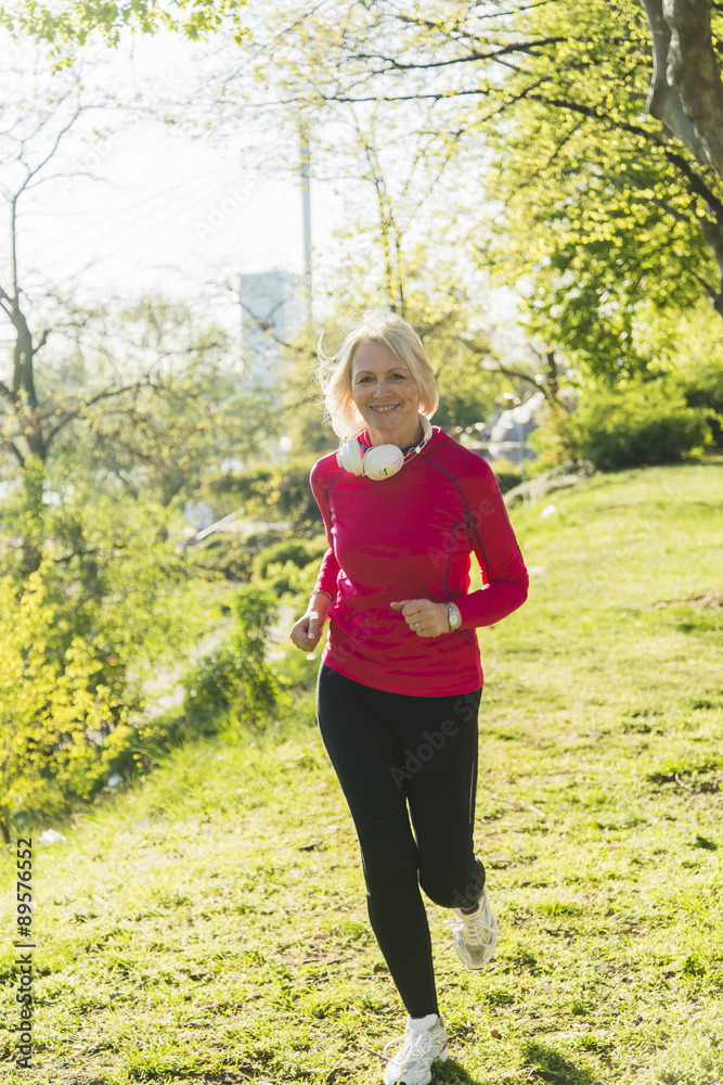 Germany, Mannheim, Mature woman jogging in park Germany, Mannheim, Mature woman jogging in park