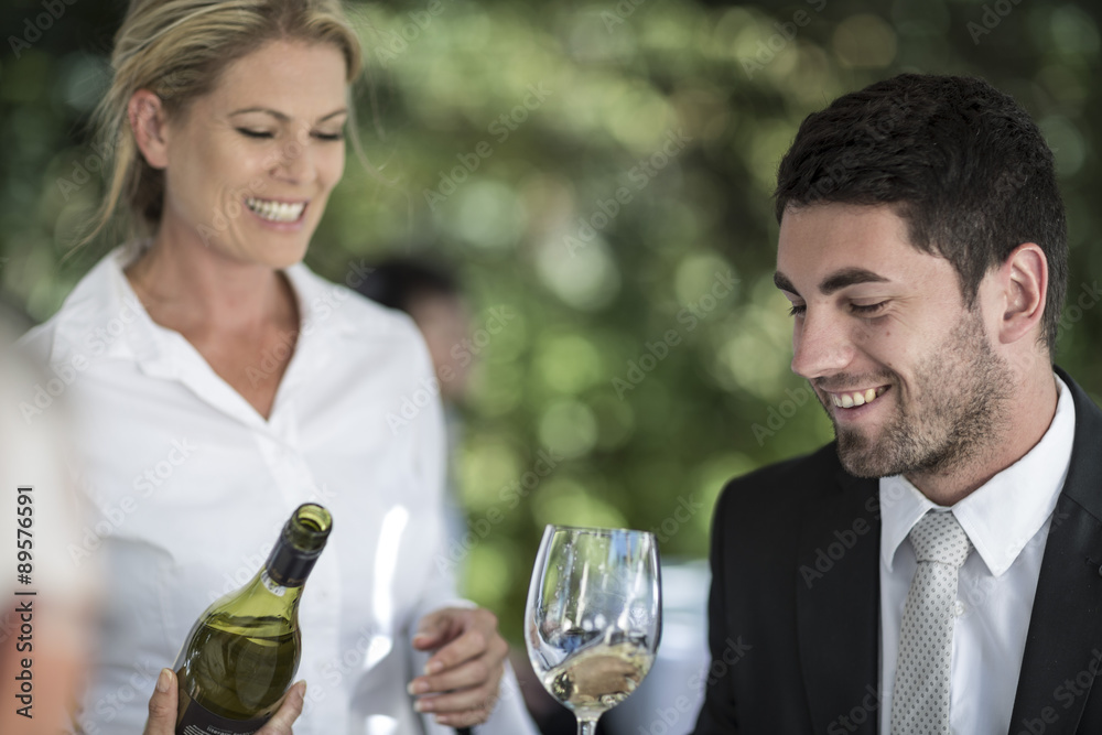 Waitress and client with glass of white wine Waitress and client with glass of white wine