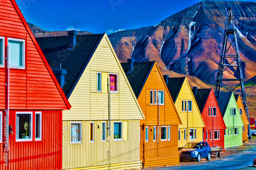 Digitally enhanced row of very colorful homes in Svalsbard, Norw