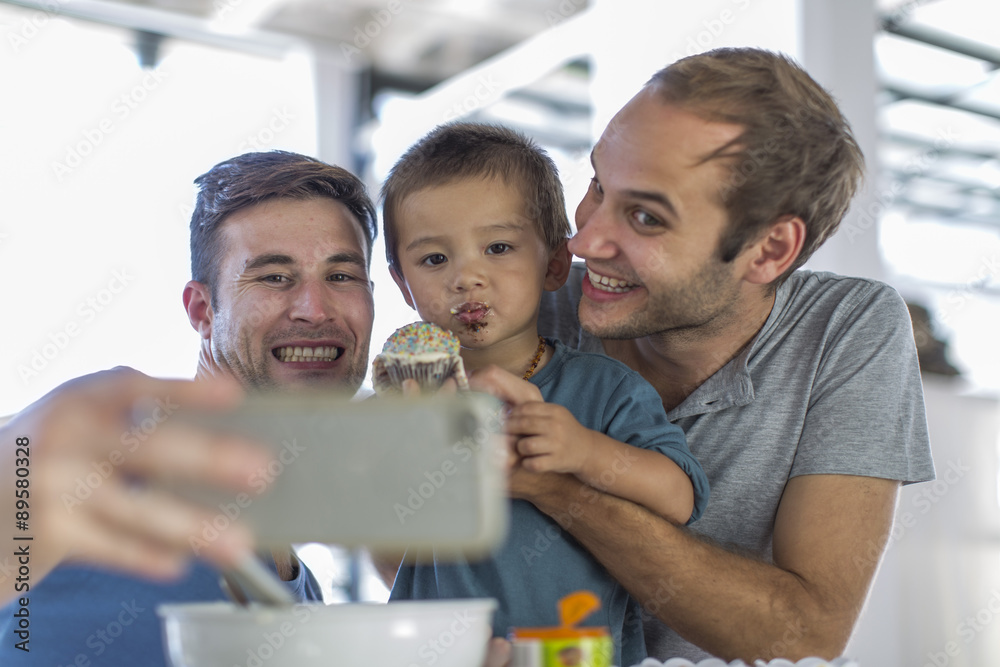 Gay couple baking cake with son Gay couple baking cake with son