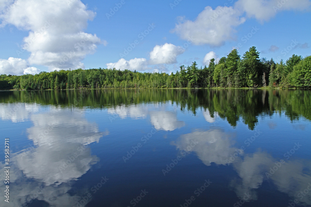 Puffy Clouds Reflected in Calm Lake