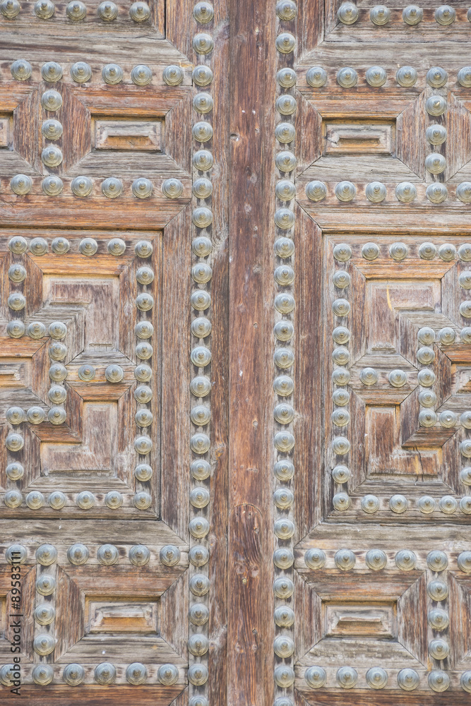 Vintage, old wooden door Castilian style in Toledo Spain